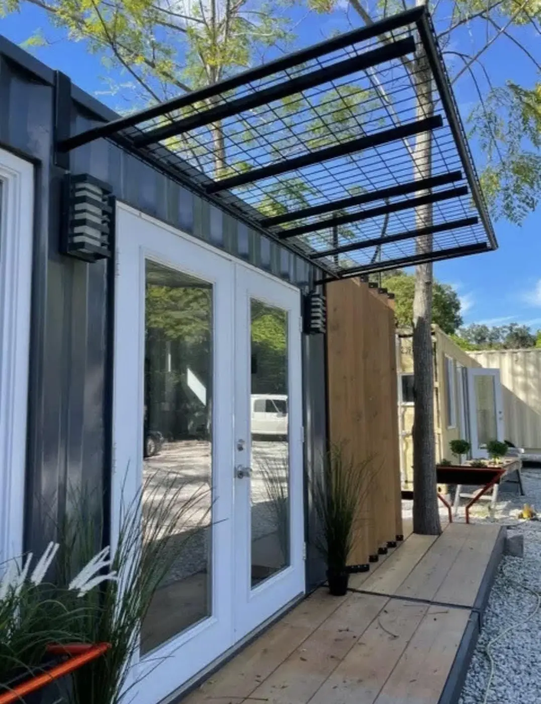 Container tiny home porch with steel pergola